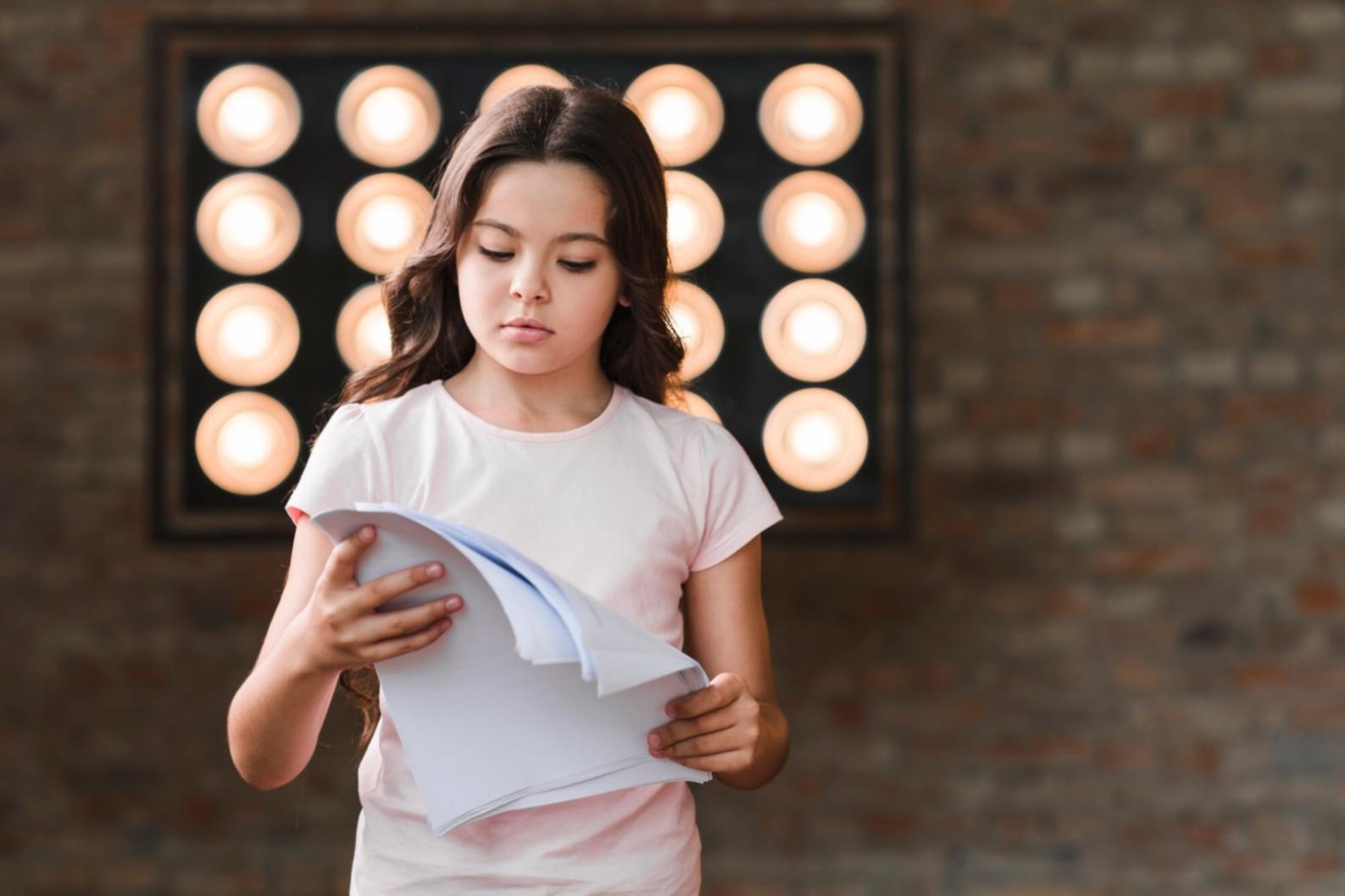 Acting student practising facial expressions during an online session